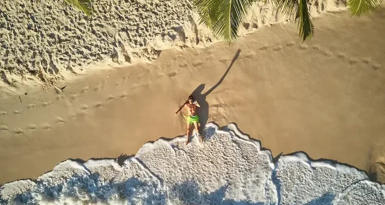 man-on-beach-at-seychelles-aerial-top-view-2024-10-11-04-27-30-utc