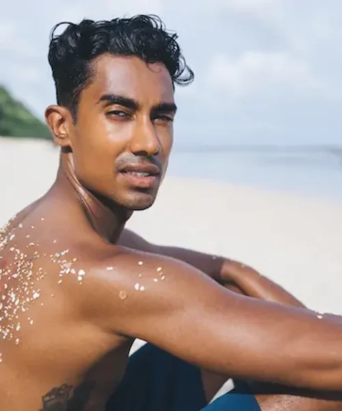 young-man-relaxing-at-beach-2023-11-27-05-02-02-utc