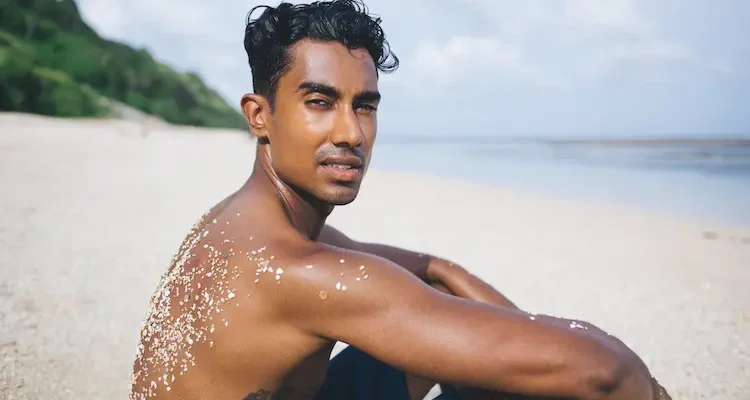 young-man-relaxing-at-beach-2023-11-27-05-02-02-utc
